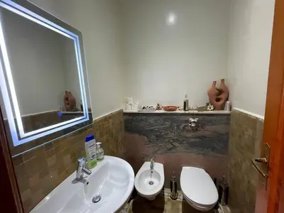 a bathroom with a sink and a toilet and a mirror at Au Temps Des Fleurs - Marrakech in Marrakech