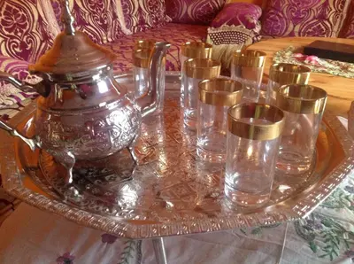 a glass tray with a tea kettle and glasses on a table at Manis Apartment Set in a Hotel Area in Marrakech
