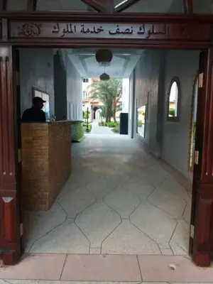 a man sitting at a counter in a building at Manis Apartment Set in a Hotel Area in Marrakech