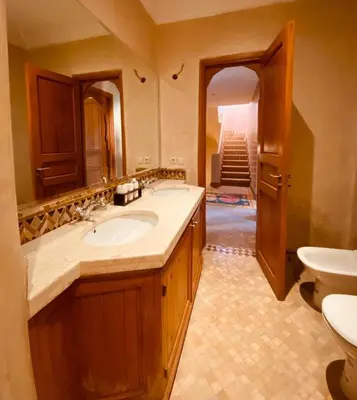 a bathroom with a sink and a toilet at Villa Talmoulkt Familiale in Marrakech