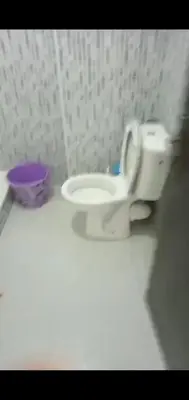 a white toilet in a bathroom with a purple bowl at Samlalia home in Marrakech
