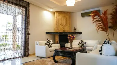 a living room with white furniture and a fireplace at Luxury heated pool Villa Marrakech in Marrakech
