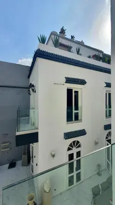 a white building with a window and a balcony at Riad VIP Bed & Breakfast in Marrakech