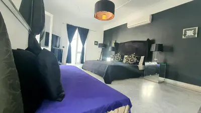 a bedroom with a bed with a purple blanket at Riad VIP Bed & Breakfast in Marrakech
