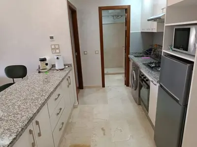 a kitchen with a sink and a stove top oven at appartement en résidence in Marrakech