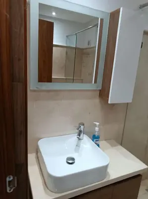 a bathroom with a white sink and a mirror at appartement en résidence in Marrakech