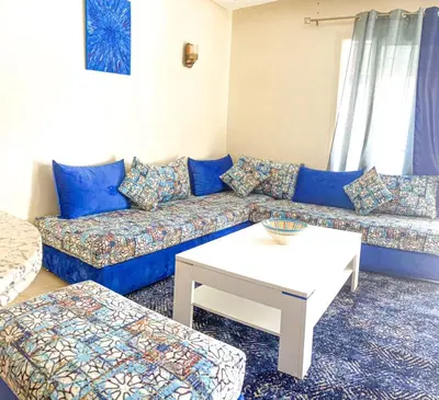 a living room with a couch and a table at appartement génial in Marrakech