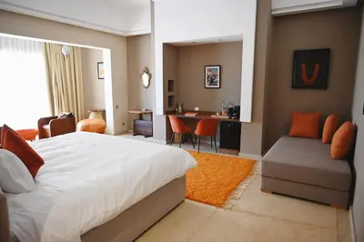 a bedroom with a bed and a table and chairs at Maison Kenoosha Boutique Hotel & Spa in Marrakech