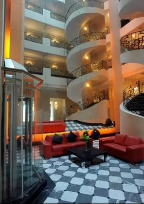 a living room with red couches in a building at Appartement Hivernage M Avenue in Marrakech