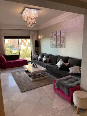a living room with a couch and a table at Appartement Hivernage M Avenue in Marrakech