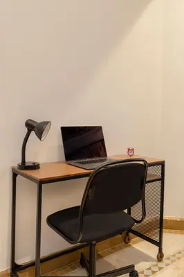 a desk with a laptop computer and a lamp at Appartement de luxe à Palmeraie Village 2 in Marrakech