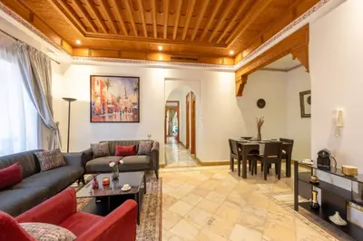 a living room with a couch and a table at Appartement de luxe à Palmeraie Village 2 in Marrakech