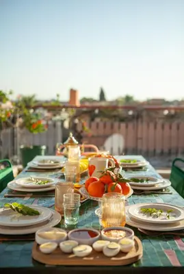 a table with plates of food on top at Cosy Riad in Marrakech