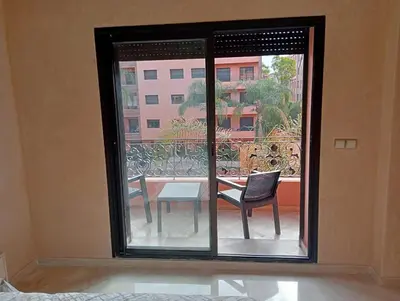 a room with a window with a table and chairs at Lovely Marrakech in Marrakech