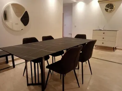 a black table and chairs in a room with a dresser at Lovely Marrakech in Marrakech