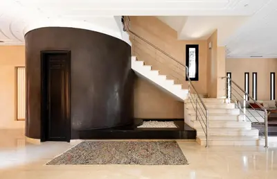 a staircase in a building with a black wall at Villa les Palmiers in Marrakech