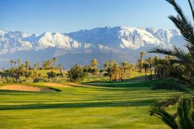 a view of a golf course with mountains in the background at Marrakech Prestigia Golf City - beauty Appartement in Marrakech