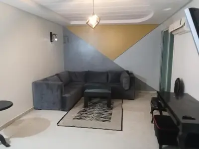 a living room with a couch and a table at Nic's apartment in Marrakech