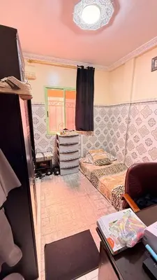a room with two beds and a tv in it at WOLFY’s Apartment in Marrakech