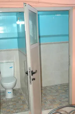 a bathroom with a toilet and a glass shower at kech hostel in Marrakech