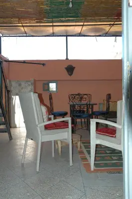a living room with two chairs and a table at kech hostel in Marrakech