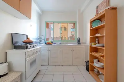 a kitchen with a white stove and a sink at Grand Cozy Apartment in Heart of Hivernage in Marrakech