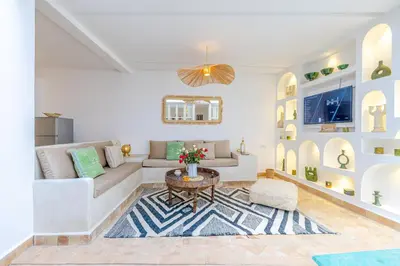 a living room with a couch and a table at Riad Agan Exclusive with New Heated Pool and Breakfast included in Marrakech