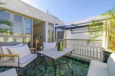 a patio with a table and chairs on a balcony at Riad Zahra b&b your private house in Marrakech in Marrakech