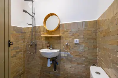 a bathroom with a sink and a mirror on a brick wall at Riad Zahra b&b your private house in Marrakech in Marrakech