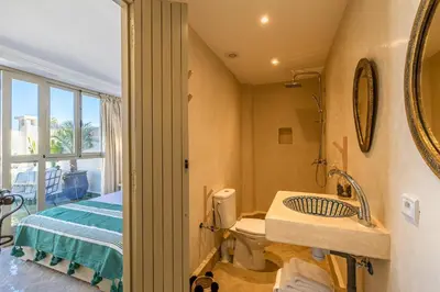 a bathroom with a sink and a toilet and a bed at Riad Zahra b&b your private house in Marrakech in Marrakech