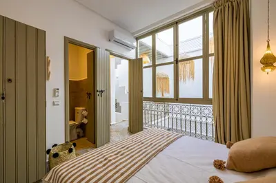 a bedroom with a bed and a large window at Riad Zahra b&b your private house in Marrakech in Marrakech