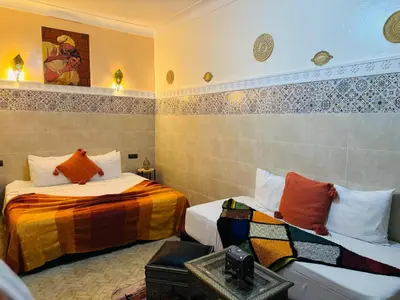a room with two beds in a room at RIAD MAMAHOUSE in Marrakech