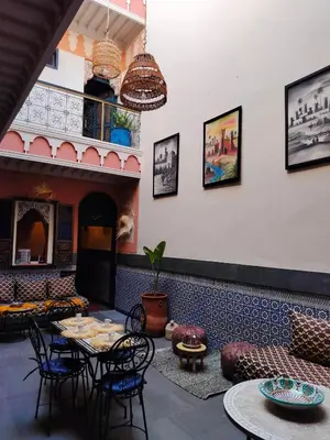 a restaurant with a table and chairs in a room at RIAD MAMAHOUSE in Marrakech