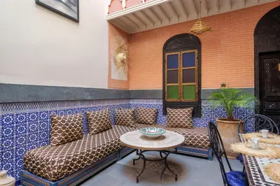 a patio with a couch and a table at RIAD MAMAHOUSE in Marrakech