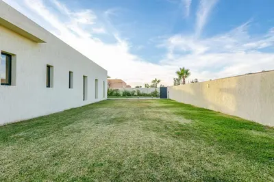 an empty yard next to a concrete wall at Villa Victoria, piscine Chauffée, sans vis à vis in Marrakech