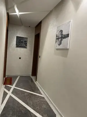 an empty hallway with two pictures on the wall at Appartement 2 ch in Marrakech