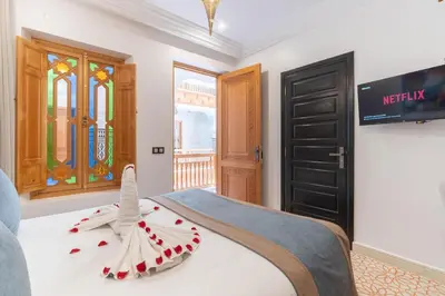 a bedroom with a bed with a toy bird on it at Riad Atlas Palace & SPA in Marrakech