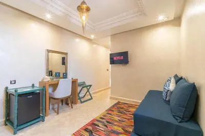 a waiting room with a couch and a tv at Riad Atlas Palace & SPA in Marrakech
