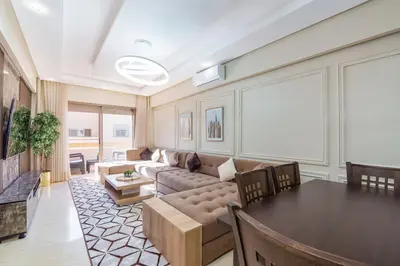 a living room with a couch and a table at Les Palmier de targa, Romantic appartement in Marrakech