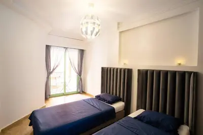 a bedroom with two beds and a window at Duplex Majorelle Marrakech in Marrakech