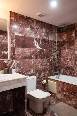 a bathroom with a toilet and a sink and a tub at Duplex Majorelle Marrakech in Marrakech