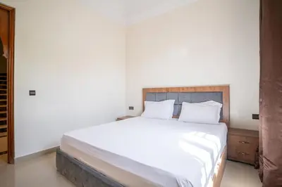 a bedroom with a large bed with white sheets and pillows at Royal mirage villa(families only) in Marrakech