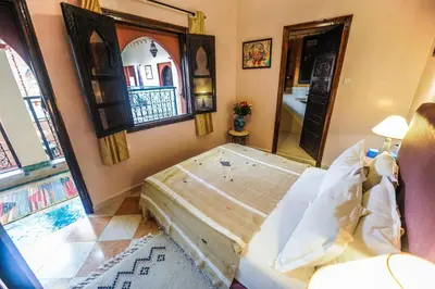 a bedroom with a large bed and a window at Riad Errabii & Spa in Marrakech