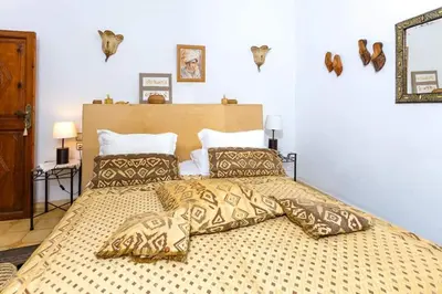 a bedroom with a large bed with pillows on it at Riad Aquarelle By GE in Marrakech