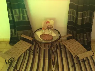 a table and two chairs with a cake on it at Riad Aquarelle By GE in Marrakech