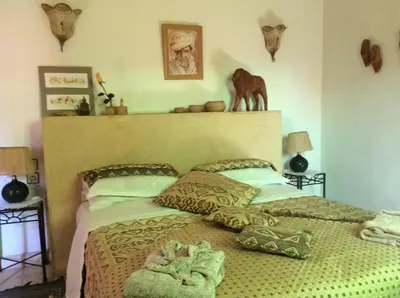 a bedroom with a bed with a horse statue above it at Riad Aquarelle By GE in Marrakech