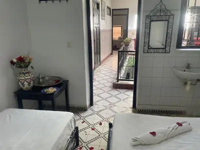 a hospital room with a bed and a sink at HOTEL EL AMAL in Marrakech