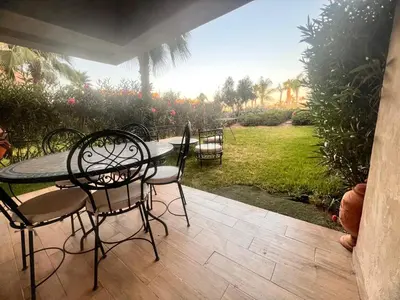 a table and chairs sitting on a patio at Opale CITY GOLF Luxe Apart 3 Rooms in Marrakech