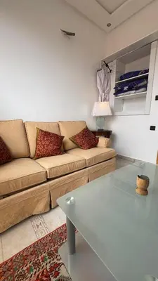 a living room with a couch and a glass table at شقة الفن Art Apartment in Marrakech