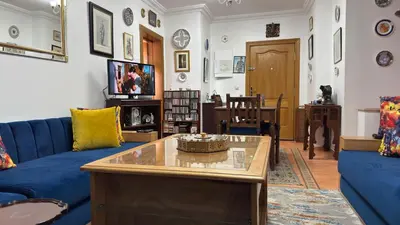 a living room with a blue couch and a table at شقة الفن Art Apartment in Marrakech